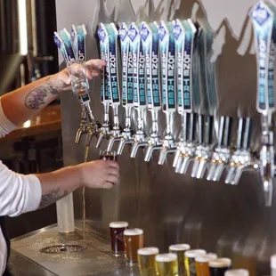 a woman filling a pint of beer