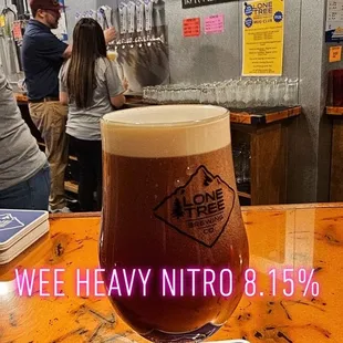 a glass of beer on a bar