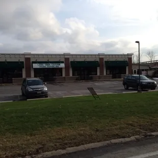 two cars parked in front of the restaurant