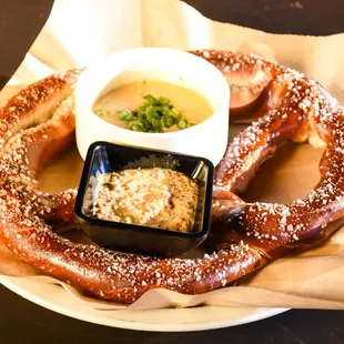 a pretzel with dipping sauce