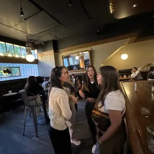 a group of women talking in a restaurant