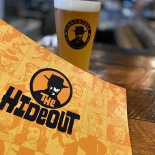 a glass of beer and a menu