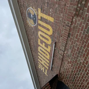 a sign on the side of a brick building