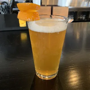 a pint of beer with a garnish