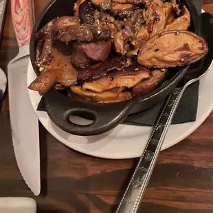 a skillet of beef and mushrooms