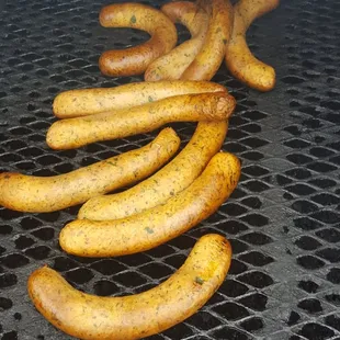 a bunch of hot dogs on a grill