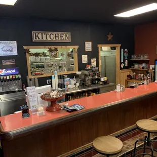 a bar with stools at the counter