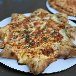 two pizzas on plates