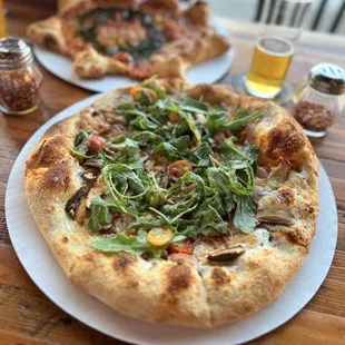 two pizzas on a table