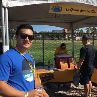 a man standing under a tent