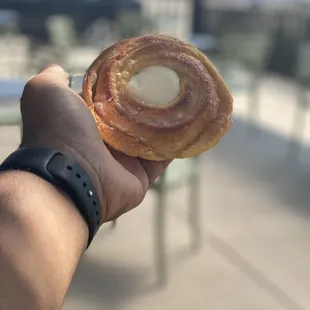 a person holding a pastry in their hand