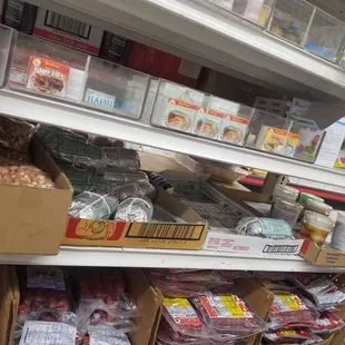 see the prepared foods on the shelf - drinks and rolled up goodies near the cash register