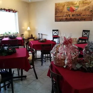 a dining room with red tablecloths and red tablecloths