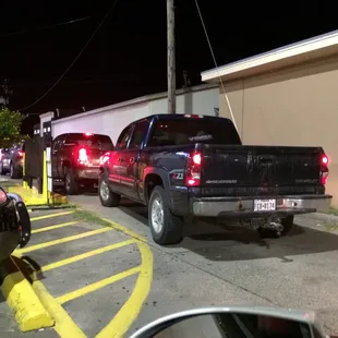 These four cars in line  have not moved in 10 minutes. I backed out and went inside and got out before this black pickup was served.