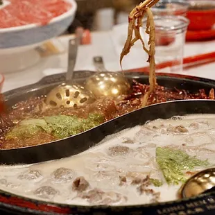 a person holding a spoon with food in it