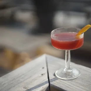 a drink in a glass on a wooden table