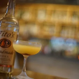 a bottle of liquor and a cocktail glass
