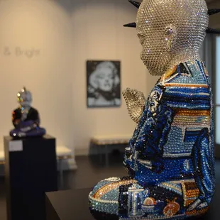 Metis Atash is an artist working with Swarvoski crystals to create buddhas paying homage to masters such as Pablo Picasso + his blue period