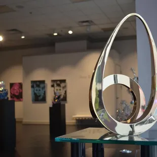 The gallery exhibits works on canvas with diamond dust by Russell Young, as well as kinetic scultpures by Tarik Currimbhoy.