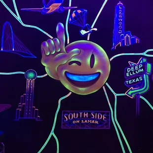a neon sign with a smiley face