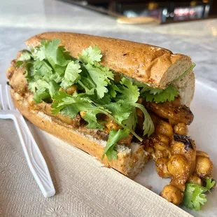 Curry sub - eggplant, chickpeas, parsley, cilantro, butter curry, yogurt, Mancini&apos;s whole wheat bread