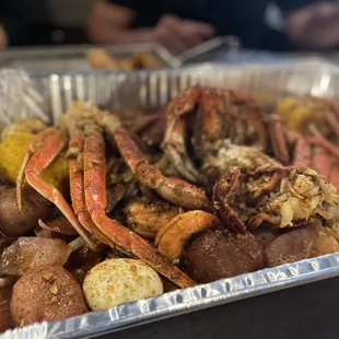 crab legs, potatoes and corn