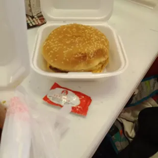 a hamburger in a styrofoam container