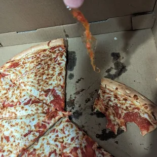 Cheese pizza with plastic