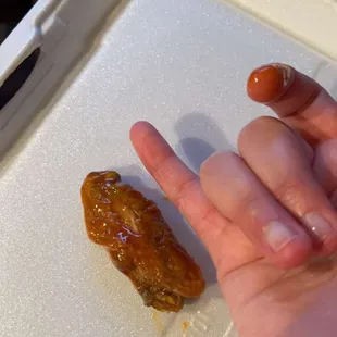 a person&apos;s hand holding a piece of food