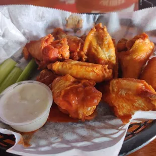 a basket of wings and celery