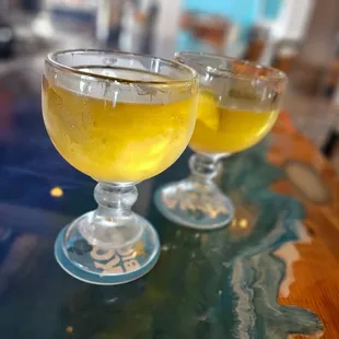 two glasses of beer on a table