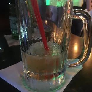 a drink in a glass with a red straw