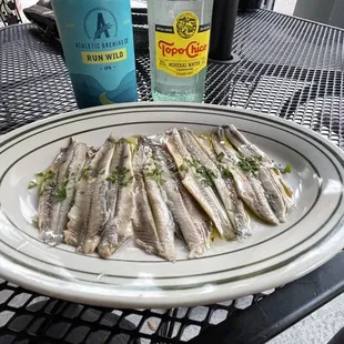 a plate of sardines on a table