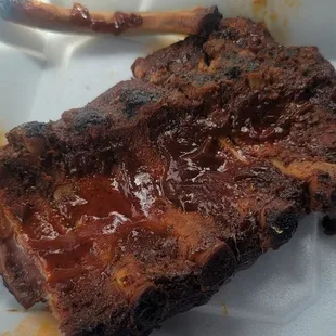 This is what passes for half a rack of ribs today it&apos;s a little smaller than my hand slobbered with sauce dry and overcooked