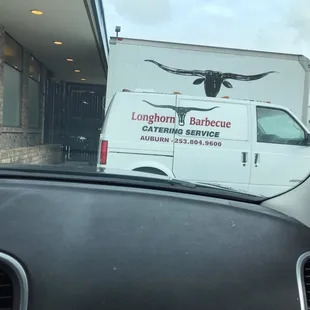 a longhorn barbecue truck parked in front of a restaurant