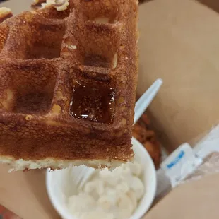 a hand holding a waffle