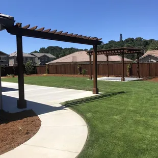 a patio with a pergolated roof