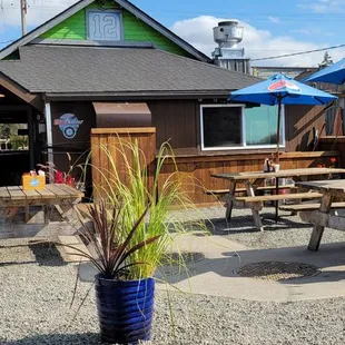 a patio with tables and umbrellas