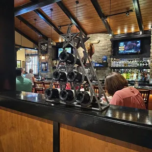a bar with people sitting at the bar