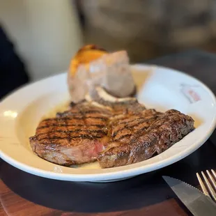 a steak on a white plate