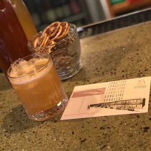 a drink and a menu on a counter