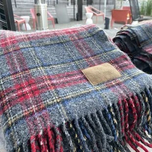 red, blue, and grey plaid blanket