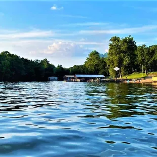 View from the water looking back at the resort and private pebble beach area our guests can experience while staying with us.