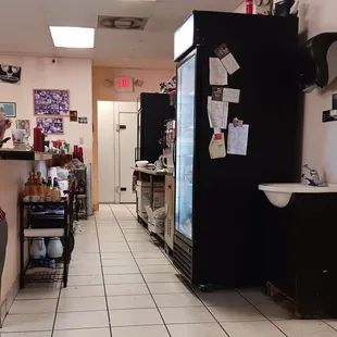 a woman standing in front of a refrigerator