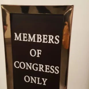 Upstairs sign in front of the elevator.