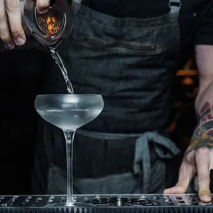 a bartender pouring a drink