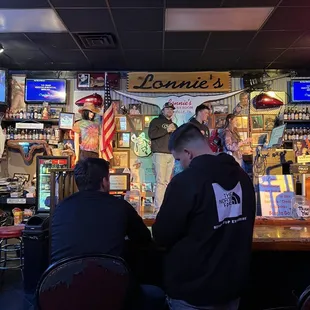 two men sitting at a bar