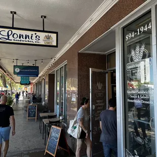 people walking down the sidewalk