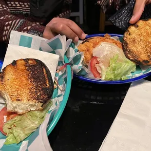 two plates of sandwiches on a table