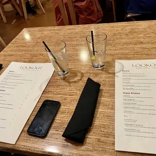 a menu and a glass of water